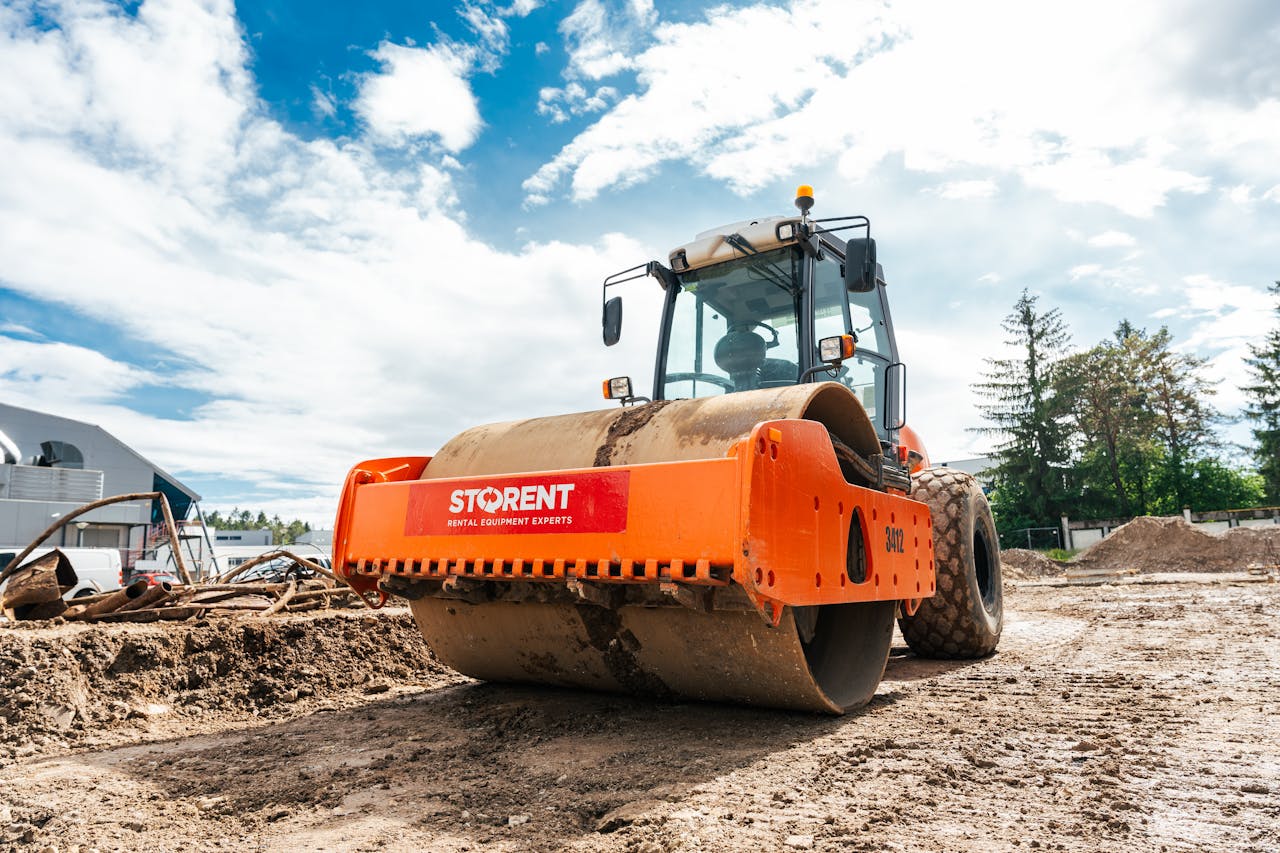 Large vibratory roller compactor on a sunny construction site in Keila, Estonia.